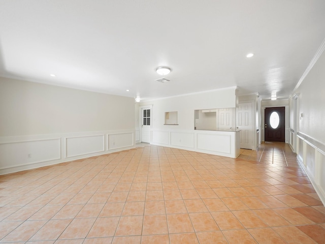 unfurnished living room featuring crown molding and light tile patterned floors