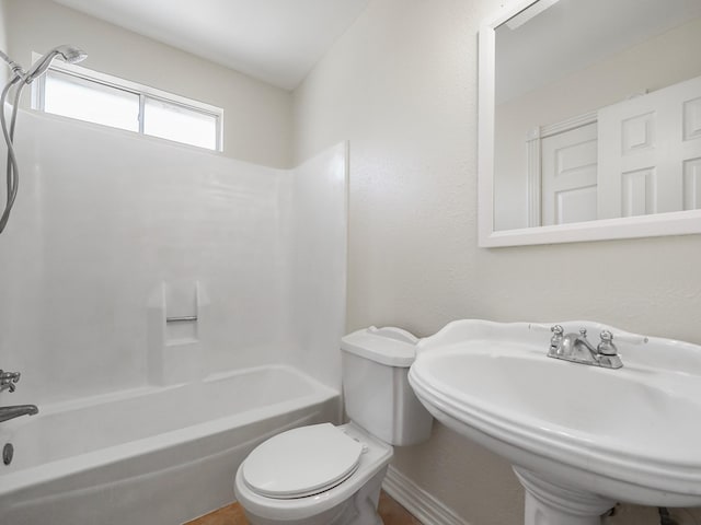 full bathroom featuring toilet, sink, and shower / bathing tub combination