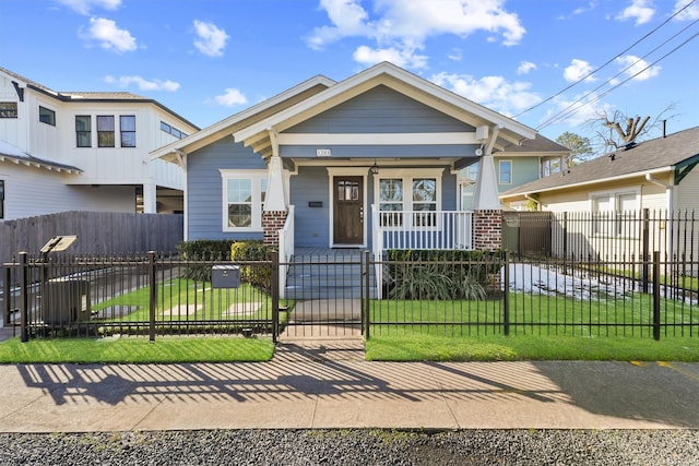 view of front facade with a front yard and covered porch