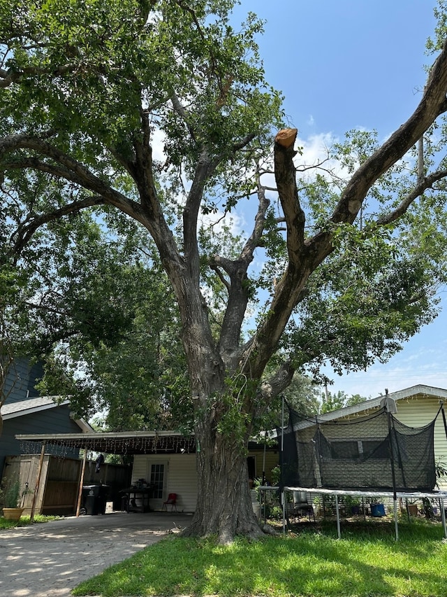 view of side of home with a trampoline