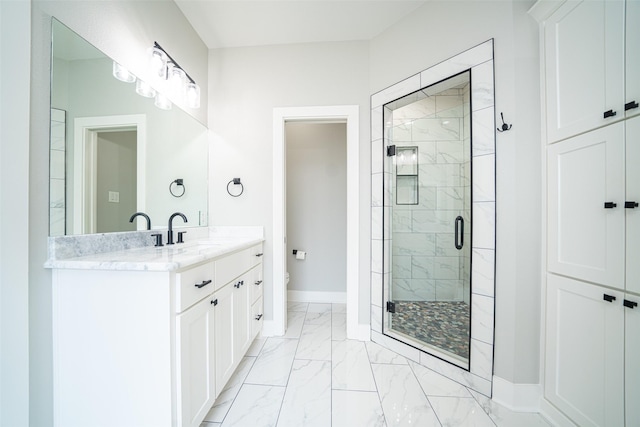 bathroom featuring vanity, an enclosed shower, and toilet