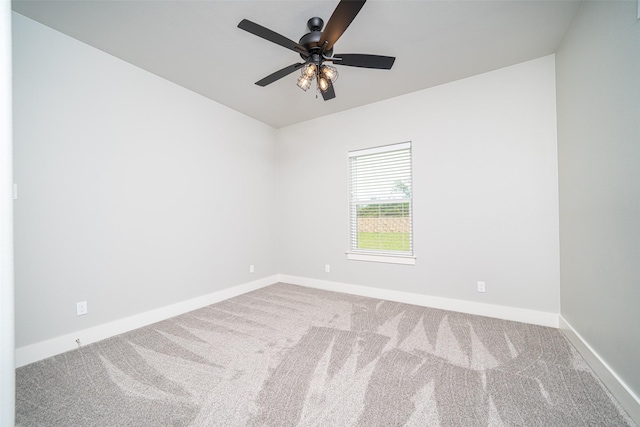 spare room featuring ceiling fan and carpet