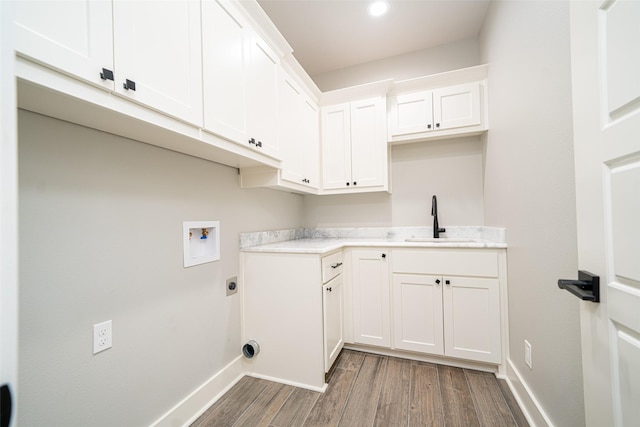 clothes washing area featuring sink, electric dryer hookup, hookup for a washing machine, cabinets, and dark hardwood / wood-style flooring