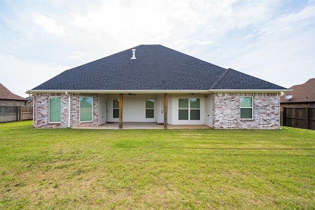 back of house featuring a yard and a patio