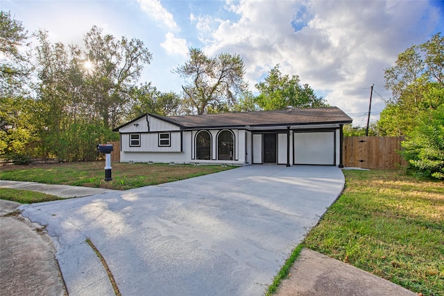 ranch-style house with a garage and a front lawn