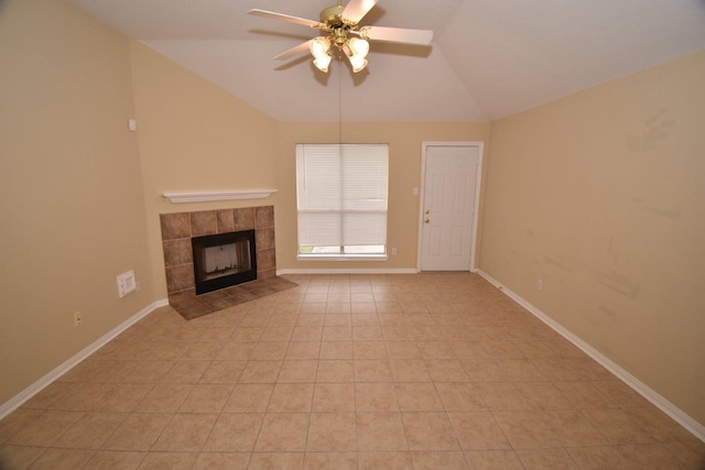 unfurnished living room with light tile patterned flooring, ceiling fan, lofted ceiling, and a fireplace