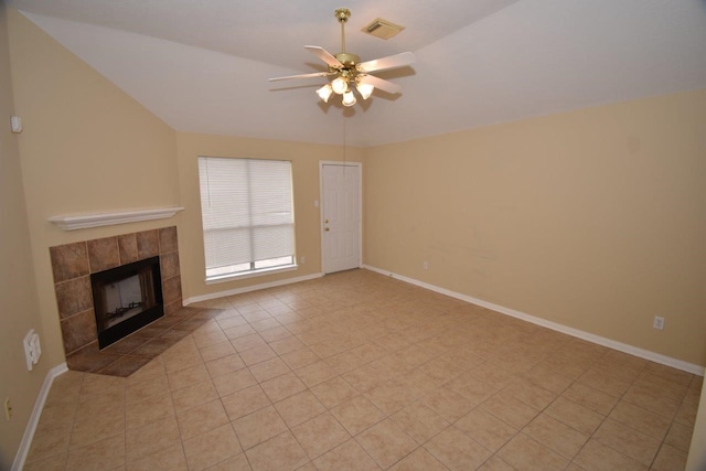 unfurnished living room featuring light tile patterned flooring, ceiling fan, a tiled fireplace, and vaulted ceiling