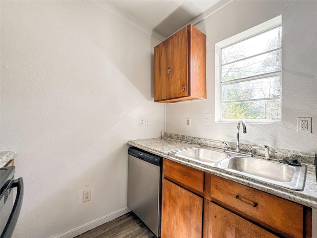 kitchen featuring ornamental molding, dark hardwood / wood-style floors, dishwasher, and sink