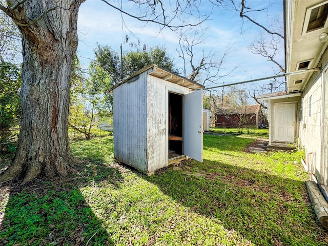 view of outbuilding with a lawn