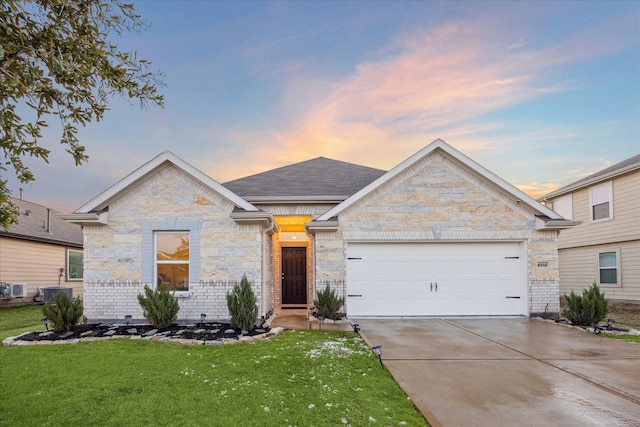 view of front of property featuring a garage and a yard