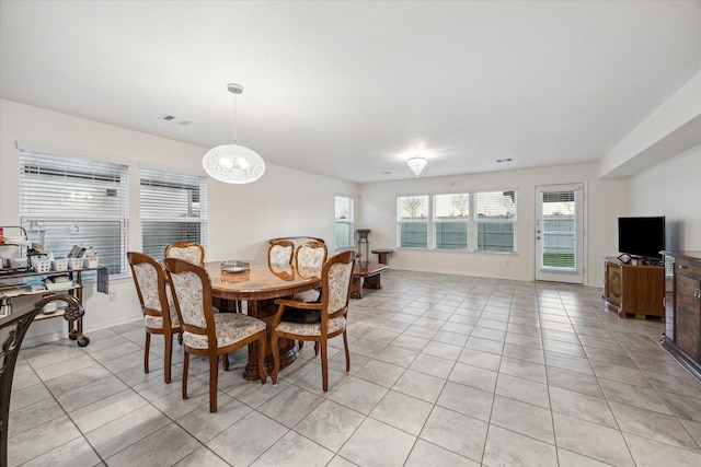 dining space featuring light tile patterned floors