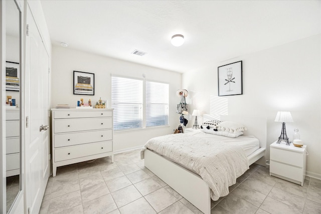 bedroom with light tile patterned floors