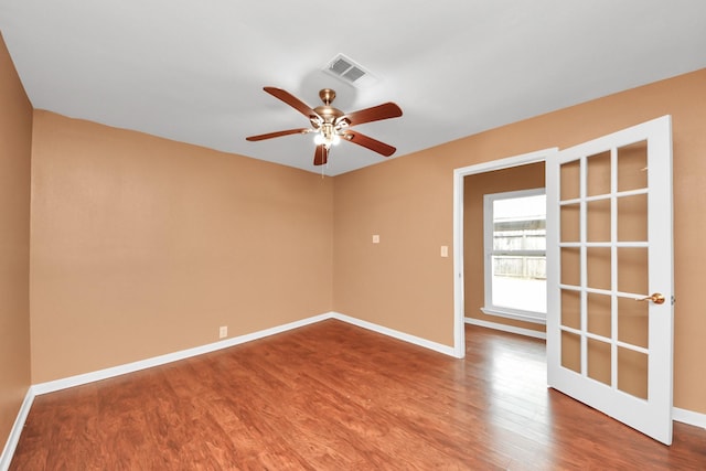 empty room featuring ceiling fan and hardwood / wood-style floors