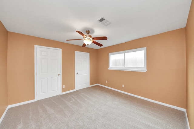 unfurnished bedroom with ceiling fan and carpet