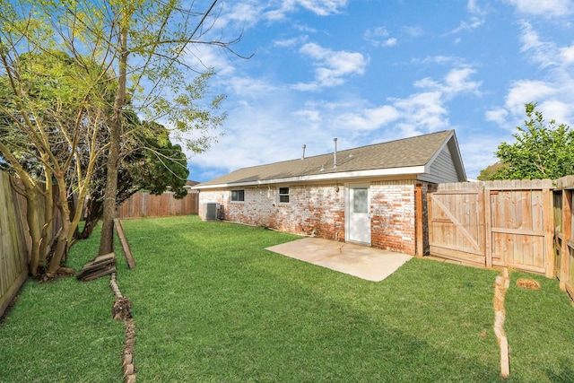 view of yard with central AC and a patio