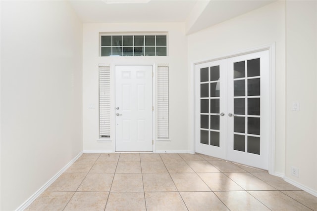 tiled foyer featuring french doors