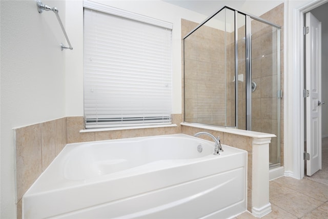 bathroom featuring tile patterned floors and separate shower and tub