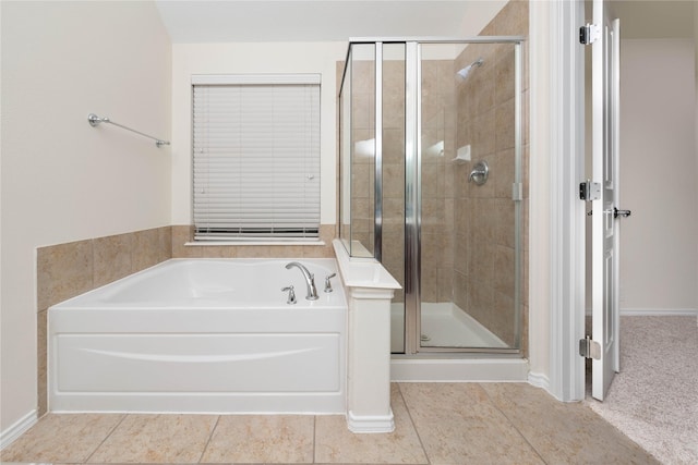 bathroom featuring tile patterned flooring and plus walk in shower