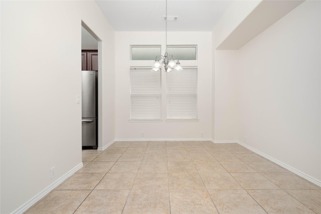 unfurnished dining area with light tile patterned floors and a chandelier