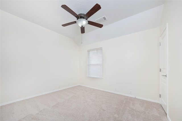 carpeted empty room featuring ceiling fan and lofted ceiling