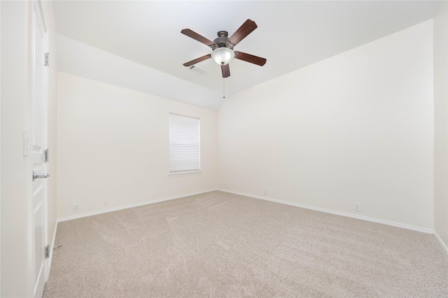 carpeted empty room featuring ceiling fan and vaulted ceiling