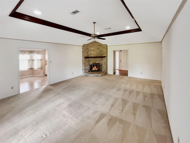 unfurnished living room featuring ceiling fan, light colored carpet, lofted ceiling, and a brick fireplace