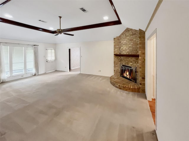 unfurnished living room with light carpet, a brick fireplace, vaulted ceiling, and ceiling fan