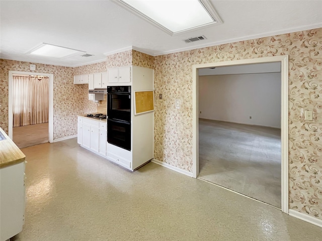 kitchen featuring white cabinetry, crown molding, black double oven, and stainless steel gas cooktop