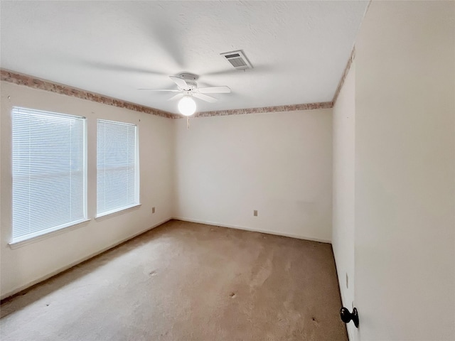 empty room with ceiling fan and carpet