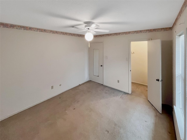 unfurnished bedroom featuring light carpet and ceiling fan