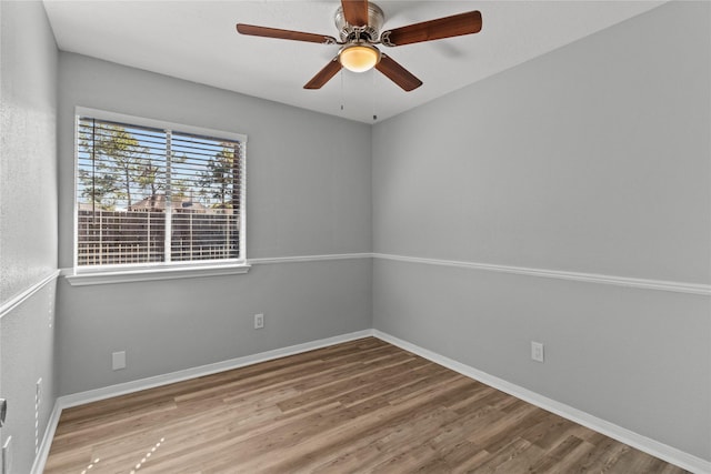 spare room featuring hardwood / wood-style flooring and ceiling fan