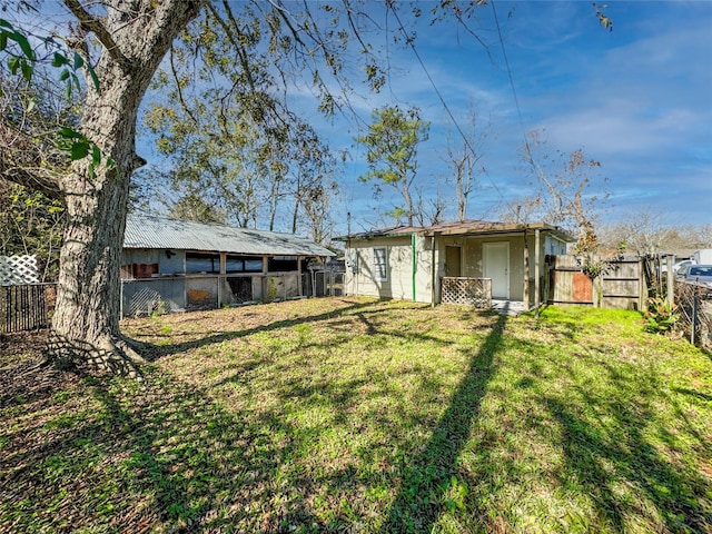 back of property featuring a yard