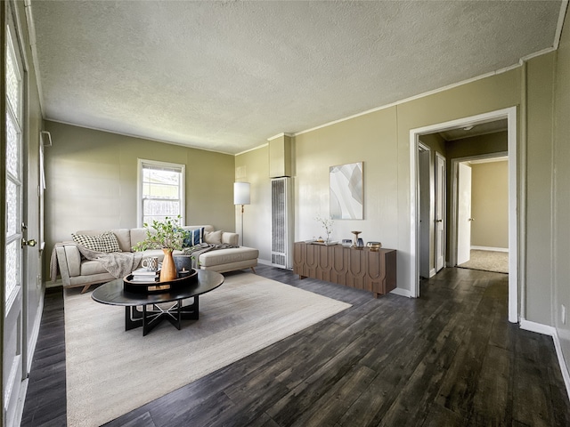 living room featuring crown molding, dark hardwood / wood-style flooring, and a textured ceiling