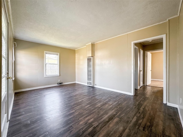 spare room featuring ornamental molding, a textured ceiling, and dark hardwood / wood-style flooring