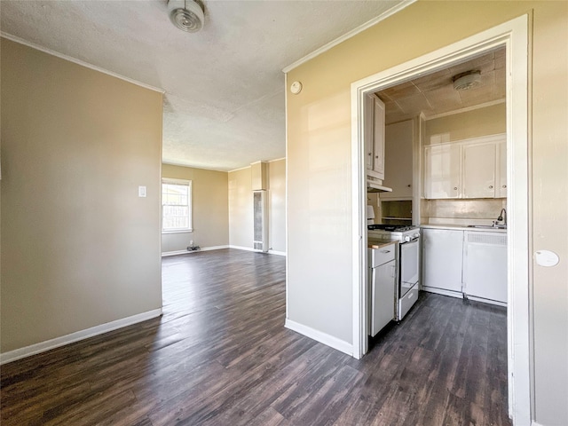 kitchen featuring dark hardwood / wood-style floors, white cabinetry, white gas range, sink, and ornamental molding