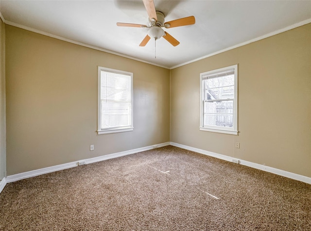 empty room featuring crown molding, carpet, a healthy amount of sunlight, and ceiling fan