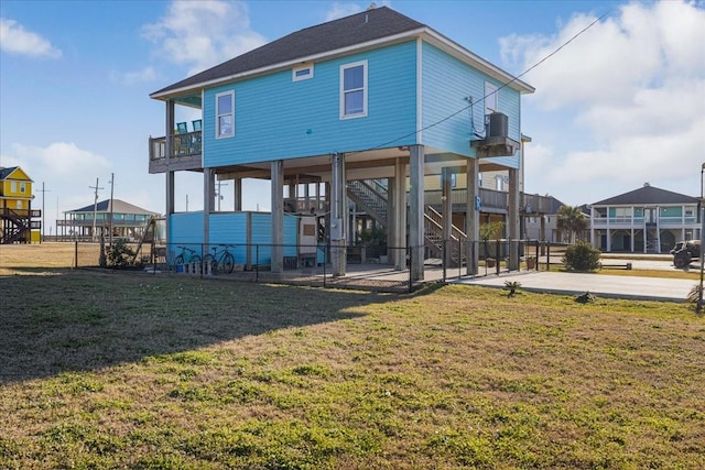 back of property featuring a lawn, a patio, a balcony, and central air condition unit