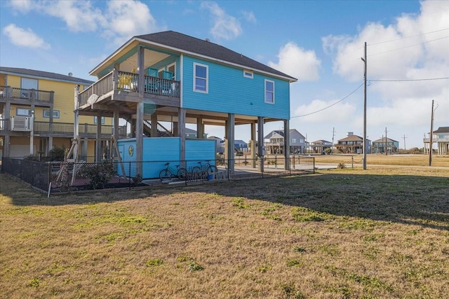 rear view of property featuring a yard and cooling unit