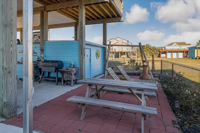 view of patio with an outbuilding and grilling area