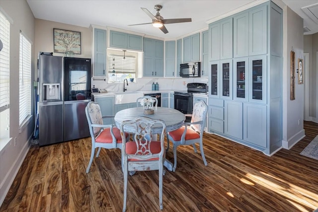 dining room featuring sink, a wealth of natural light, dark hardwood / wood-style floors, and ceiling fan