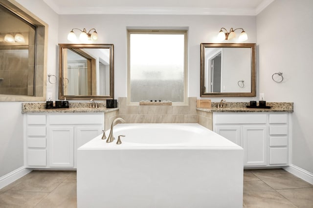 bathroom with tile patterned flooring, vanity, crown molding, and a bathtub