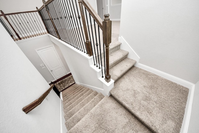 stairs featuring carpet