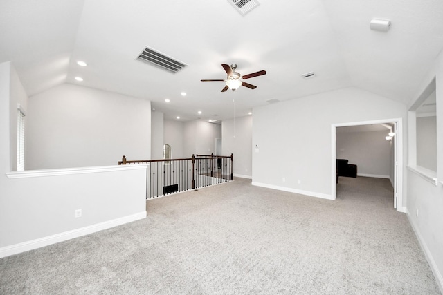 empty room featuring lofted ceiling, light colored carpet, and ceiling fan