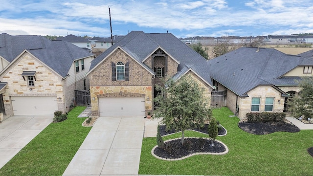 view of front of property with a garage and a front yard