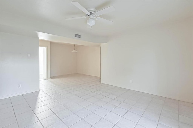 empty room with light tile patterned floors and ceiling fan