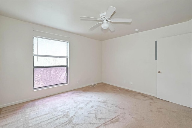 carpeted empty room featuring ceiling fan