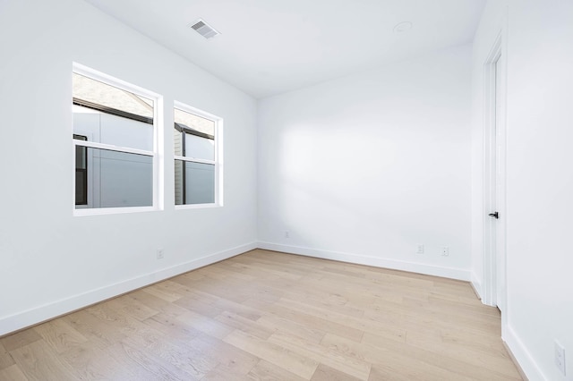 spare room with light hardwood / wood-style floors