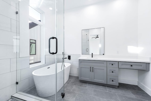 bathroom featuring vanity and independent shower and bath