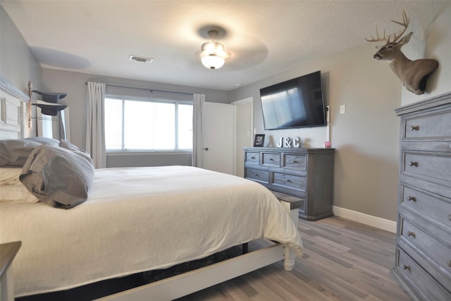 bedroom with hardwood / wood-style flooring and ceiling fan