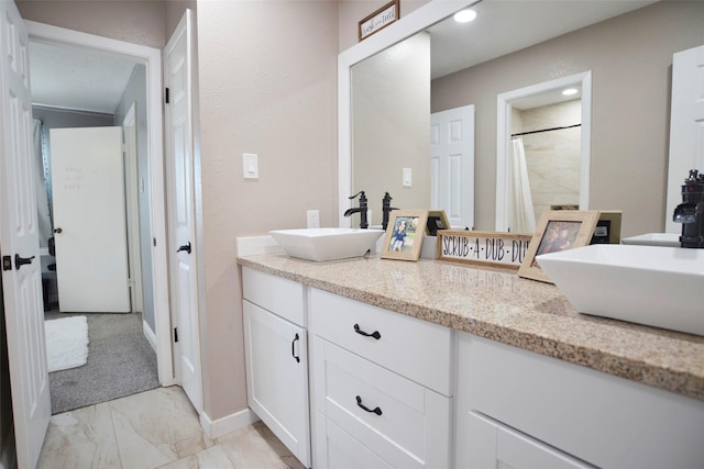 bathroom with vanity and a shower with shower curtain